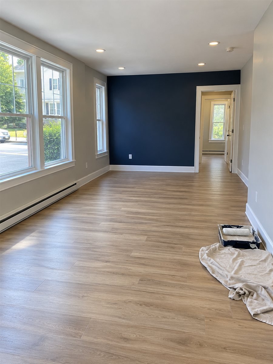 Freshly painted commercial room with gray walls and a navy accent wall